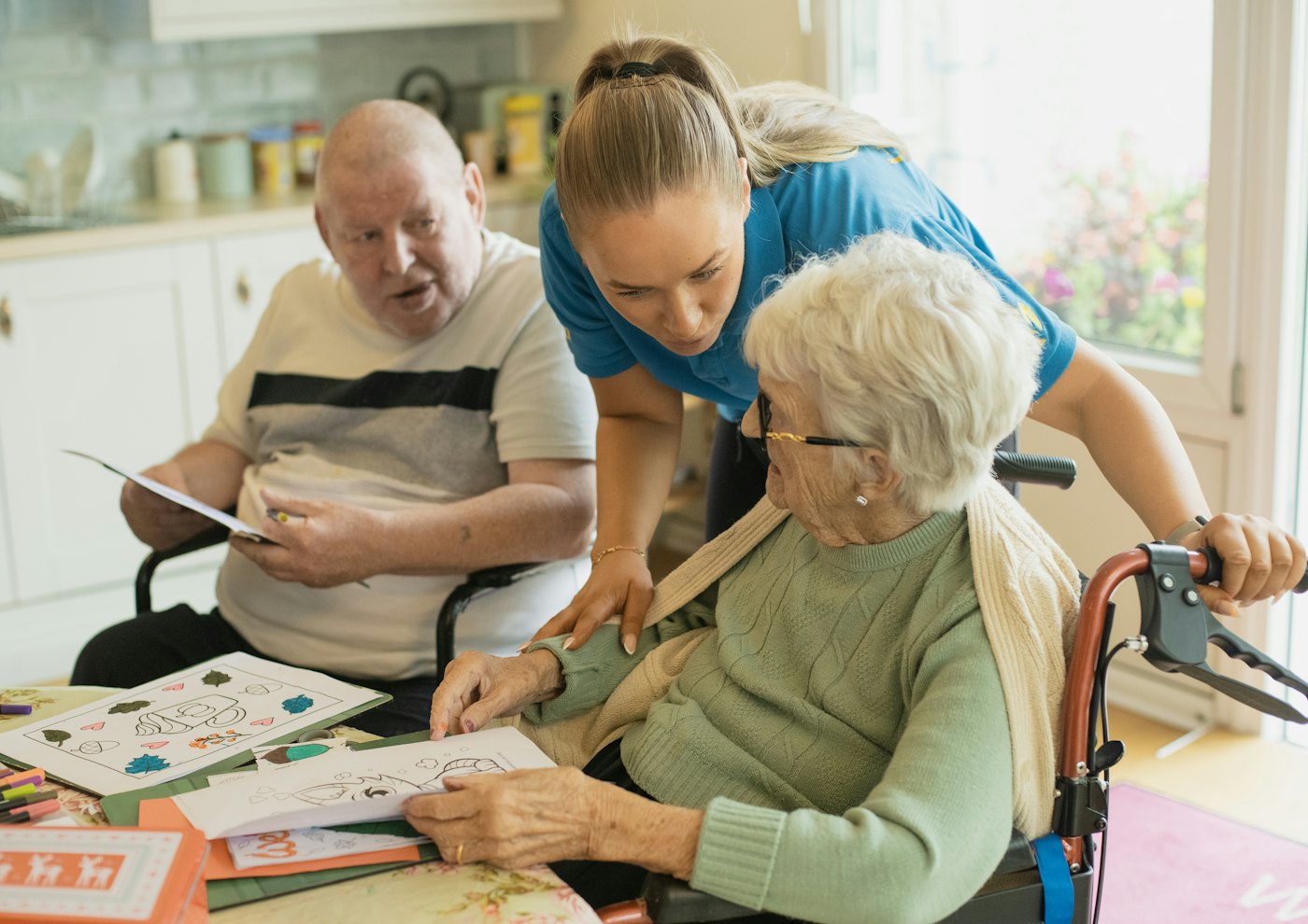 Caregiver helping an elderly couple at home