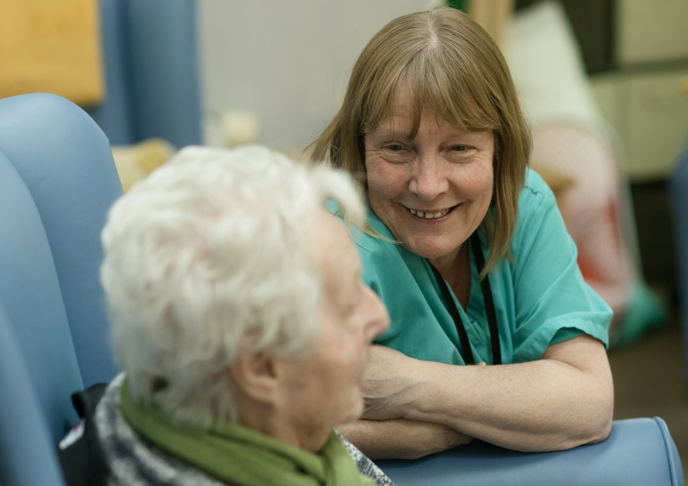 Friendly carer talking with an elderly woman