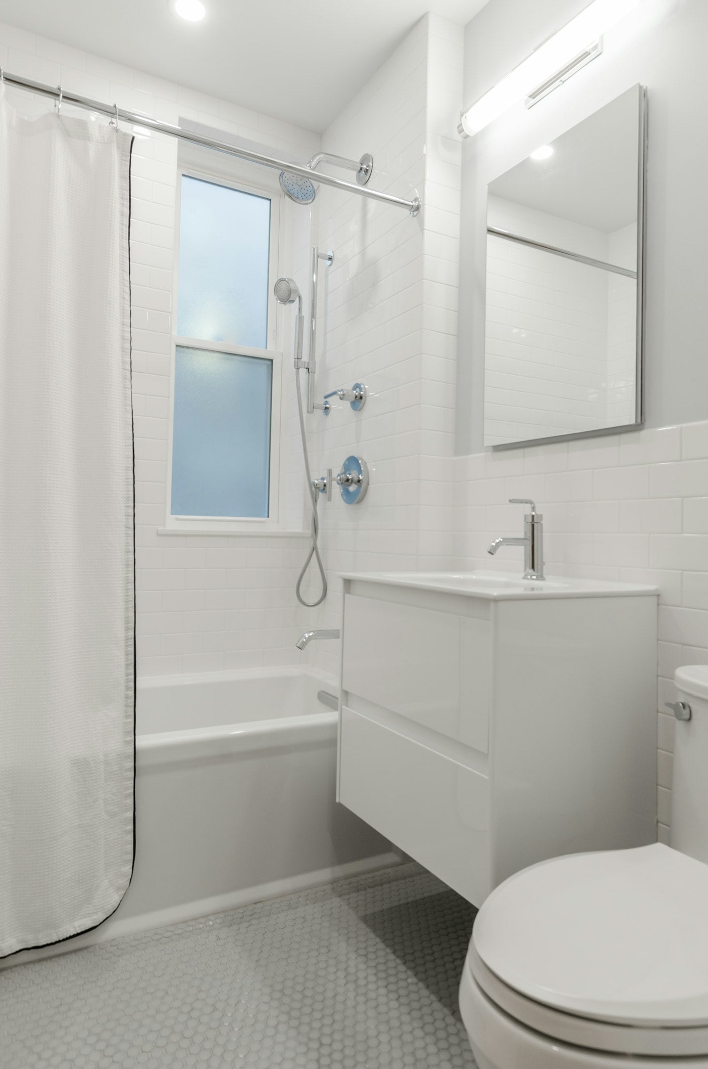 Bright, accessible bathroom with bathtub and shower